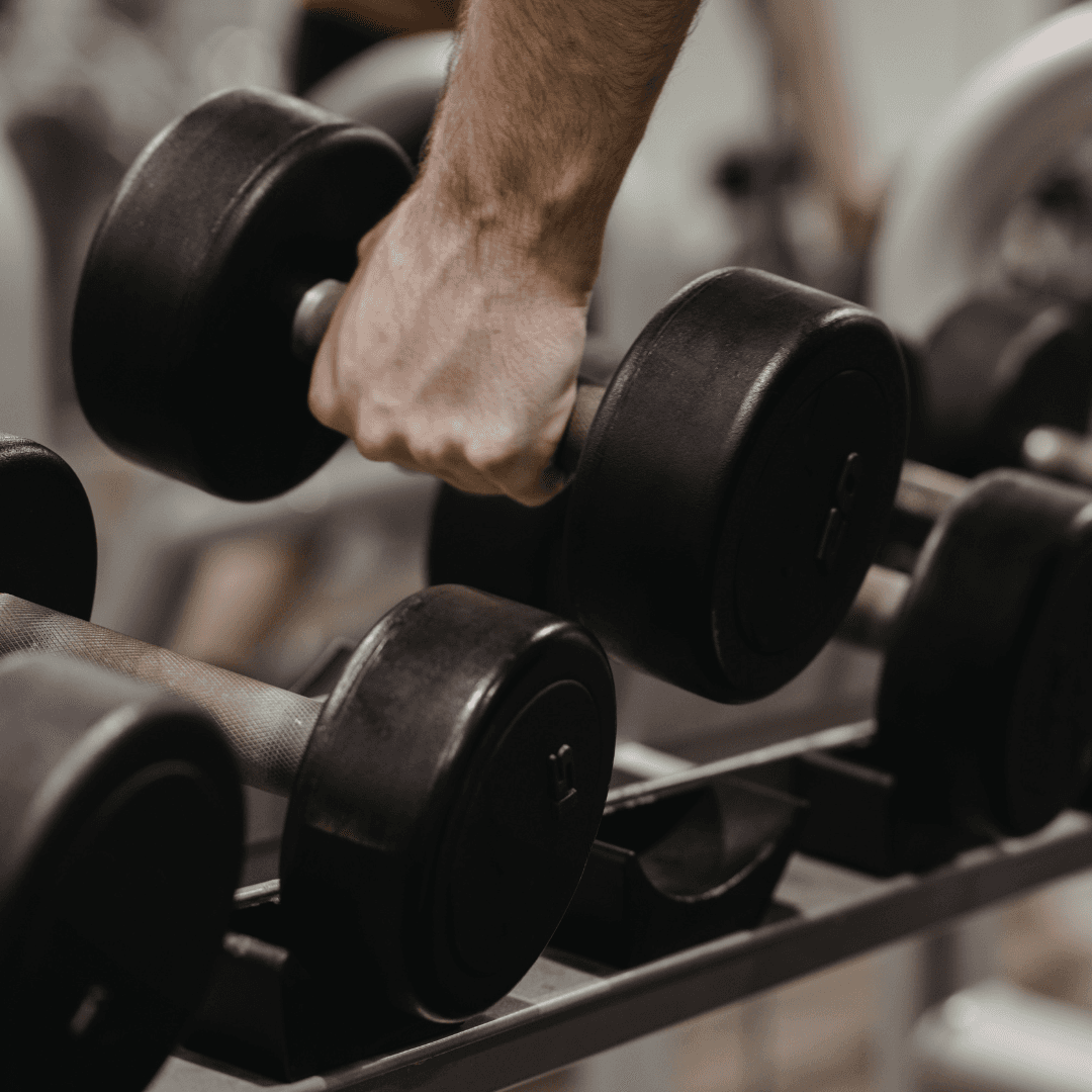 A man picking up dumbbells at InnerFit Gym