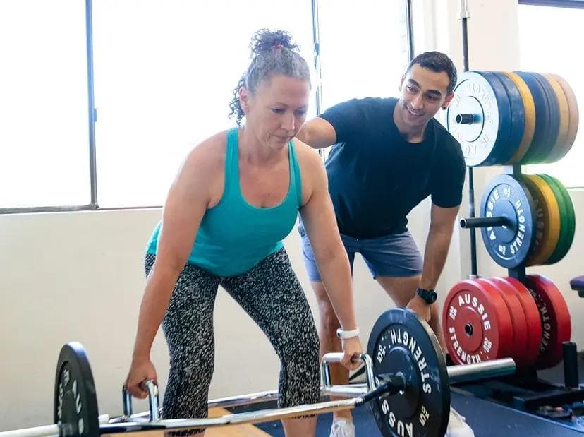 A personal training session at InnerFit. A man is training a woman