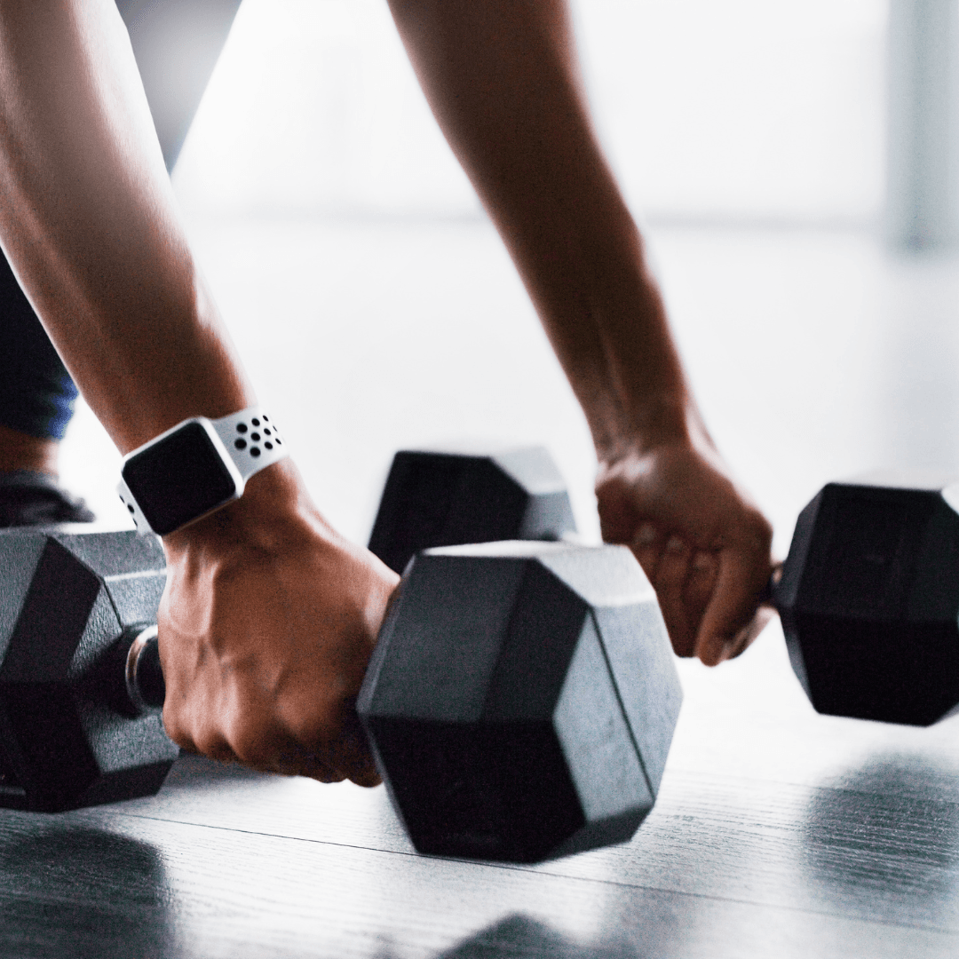 A woman holding dumbbells at InnerFit